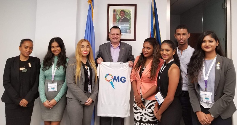 UN youth presents an SDG T-shirt to Ambassador Jumeau as a gift