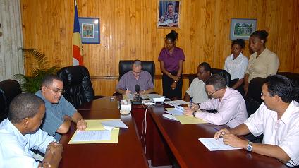 Minister Morgan (at head of table) signing the MoU with representatives of SMB (left) and SBL