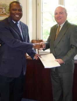 Mr Morin (right) presents Mr Osakwe with Seychelles’ Memorandum of Foreign Trade Regime 