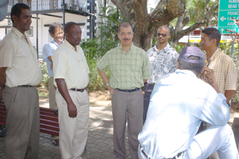 President Michel (centre) chatting with taxi drivers  (photo left) and crossing the street along Independence Avenue