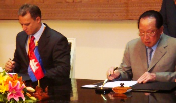 Mr Adam (left) and Mr Namhong signing the agreement