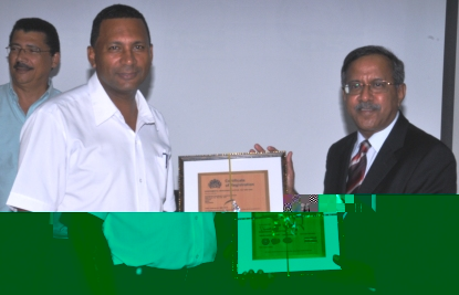 Mr Arabolu presents the (ISO) 14000 certificate to crewing manager and ISO representative Allain Asba 