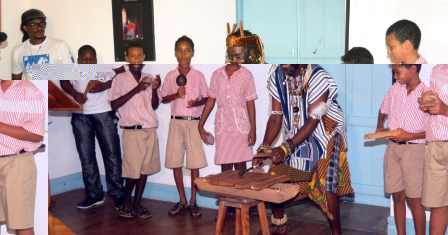 Achille ‘Kwame’ Luc, accompanied by a group of Au Cap pupils, performing a musical piece