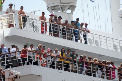 Passengers on deck as the cruise ship docks in Port Victoria