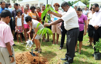 Minister Larue planting a fruit tree at the Au Cap primary school