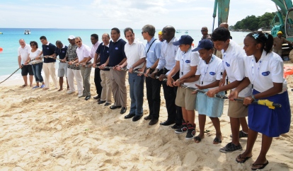 President Michel and other dignitaries, company representatives and school children symbolically pulling the cable towards the shore near Beau Vallon’s La Plage restaurant 