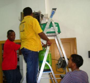 Technicians replacing gas in an air conditioning unit