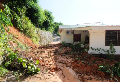 House damaged as burst pipe sends mud tumbling