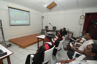 Guests and graduates watching the ceremony on the screen