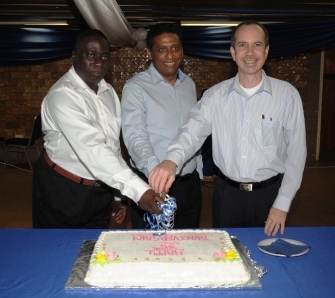Vice-President Faure, Minister Morgan and Mr Zialor cutting the anniversary cake