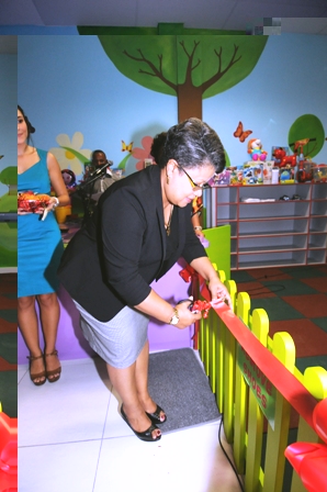 Ambassador Athanasius cutting the ribbon to officially open the playroom