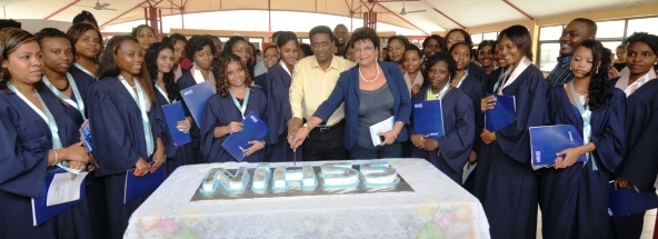 Graduates join VP Faure and Minister Mondon in cutting the cake to mark the occasion