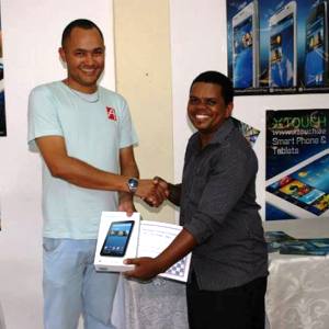 Hoareau receiving his X-Touch tablet from an X-Touch Seychelles representative