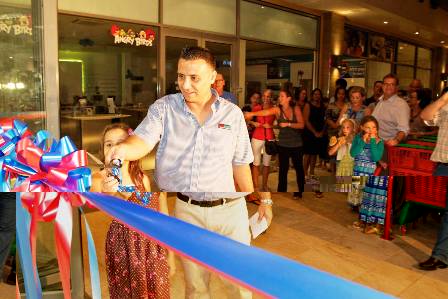 Mr Suleman cuts the ribbon to officially open the new supermarket