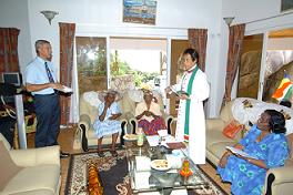 Ms Annette (seated second from left) receives the blessings of Bishop Chang-Him (right)