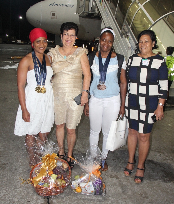 Minister Larue and Ms Rousseau in a souvenir photo with triple gold medallist Agricole and triple bronze medallist Lozaique
