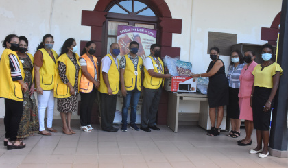 Visiting Lions Club international district governor donates home items to Health Care Agency